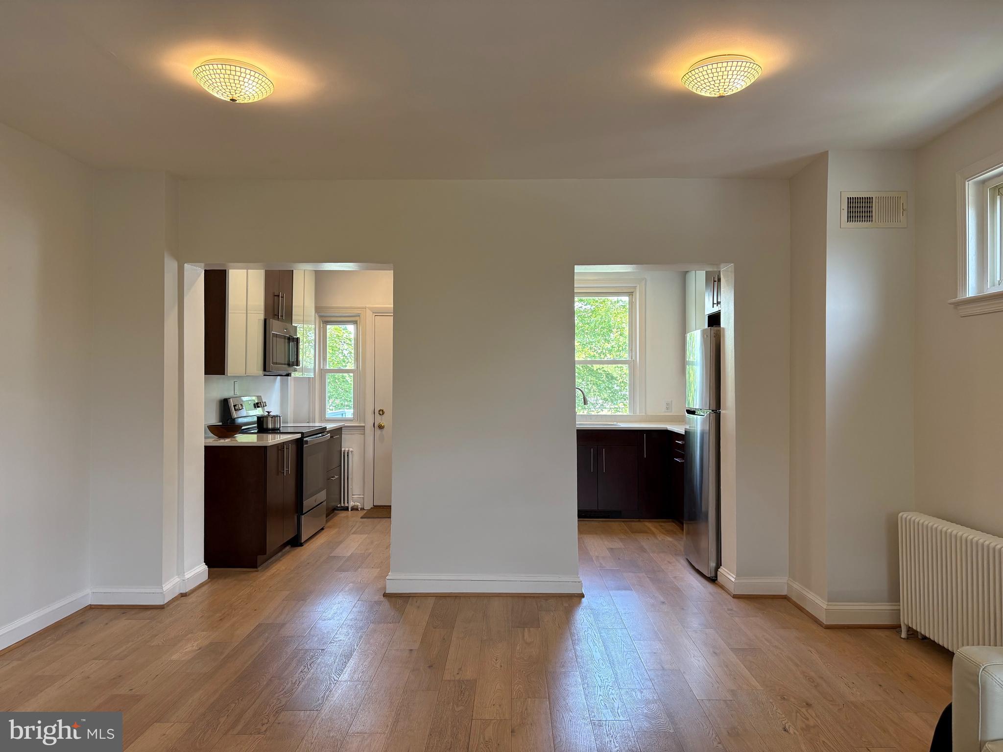1772 E Street Northeast Washington, DC 20002 - Photo 6 of 23 a view of a big room with wooden floor and windows