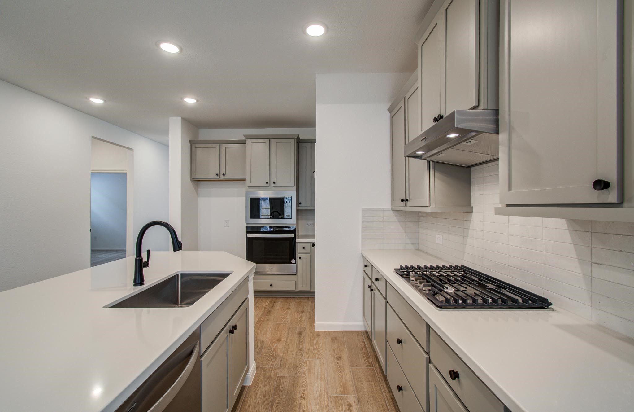 7231 Yarrow Blossom Court Katy, TX 77493 - Photo 2 of 49 a kitchen with stainless steel appliances a sink stove and cabinets