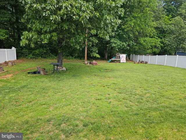 a front view of a house with a garden and trees