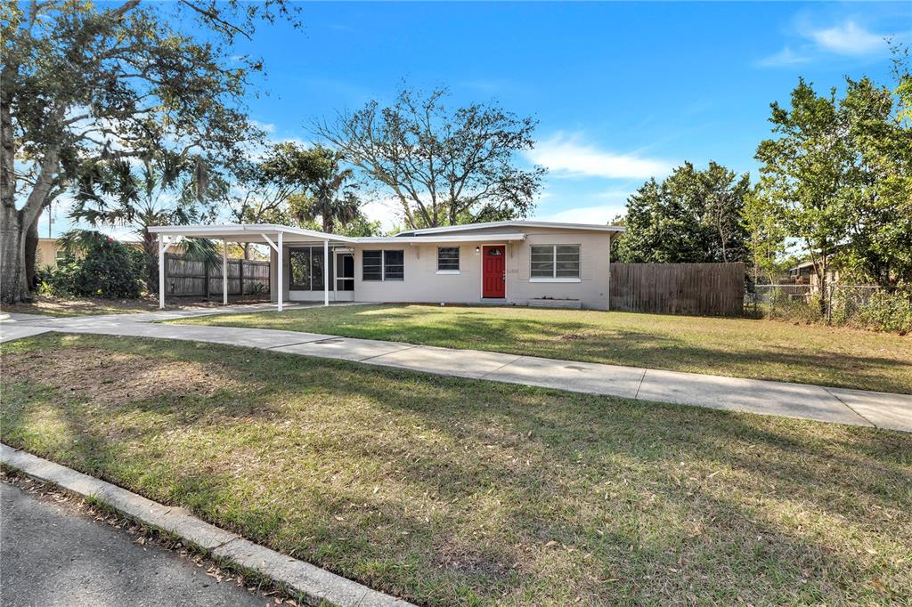 1202 Ferndell Road Orlando, FL 32808 - Photo 1 of 1 a front view of a house with a yard