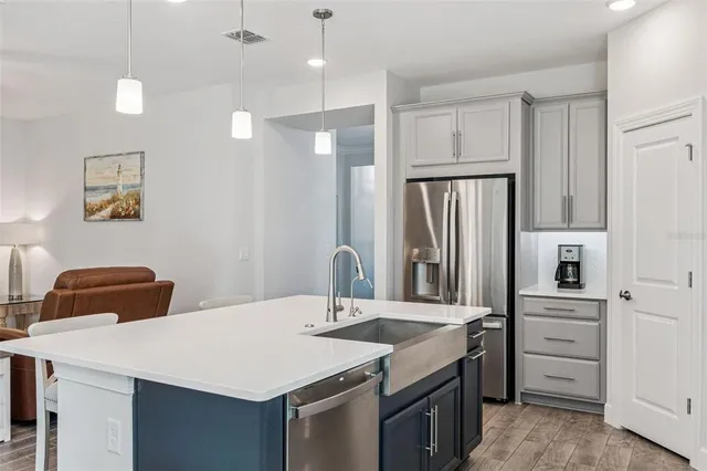 a room with a table chairs and white walls