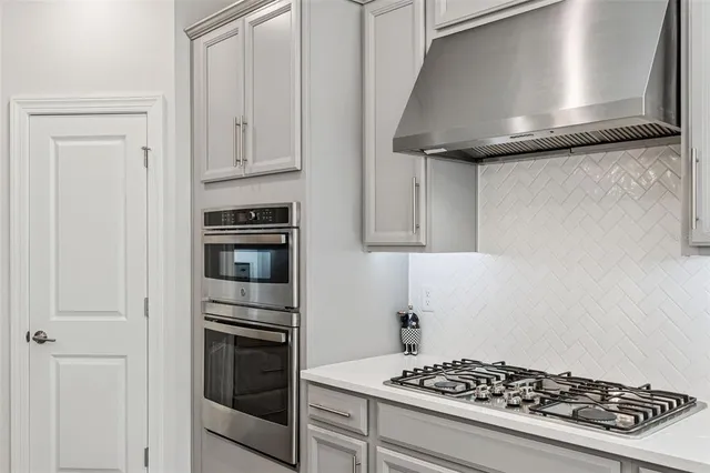 a bedroom with a bed a large window with wooden floor