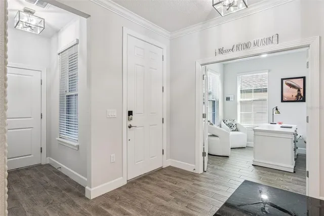 a living room with furniture and a view of kitchen