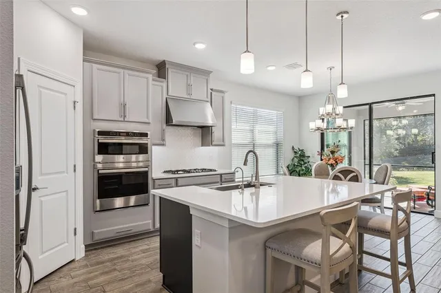a kitchen with white cabinets and appliances