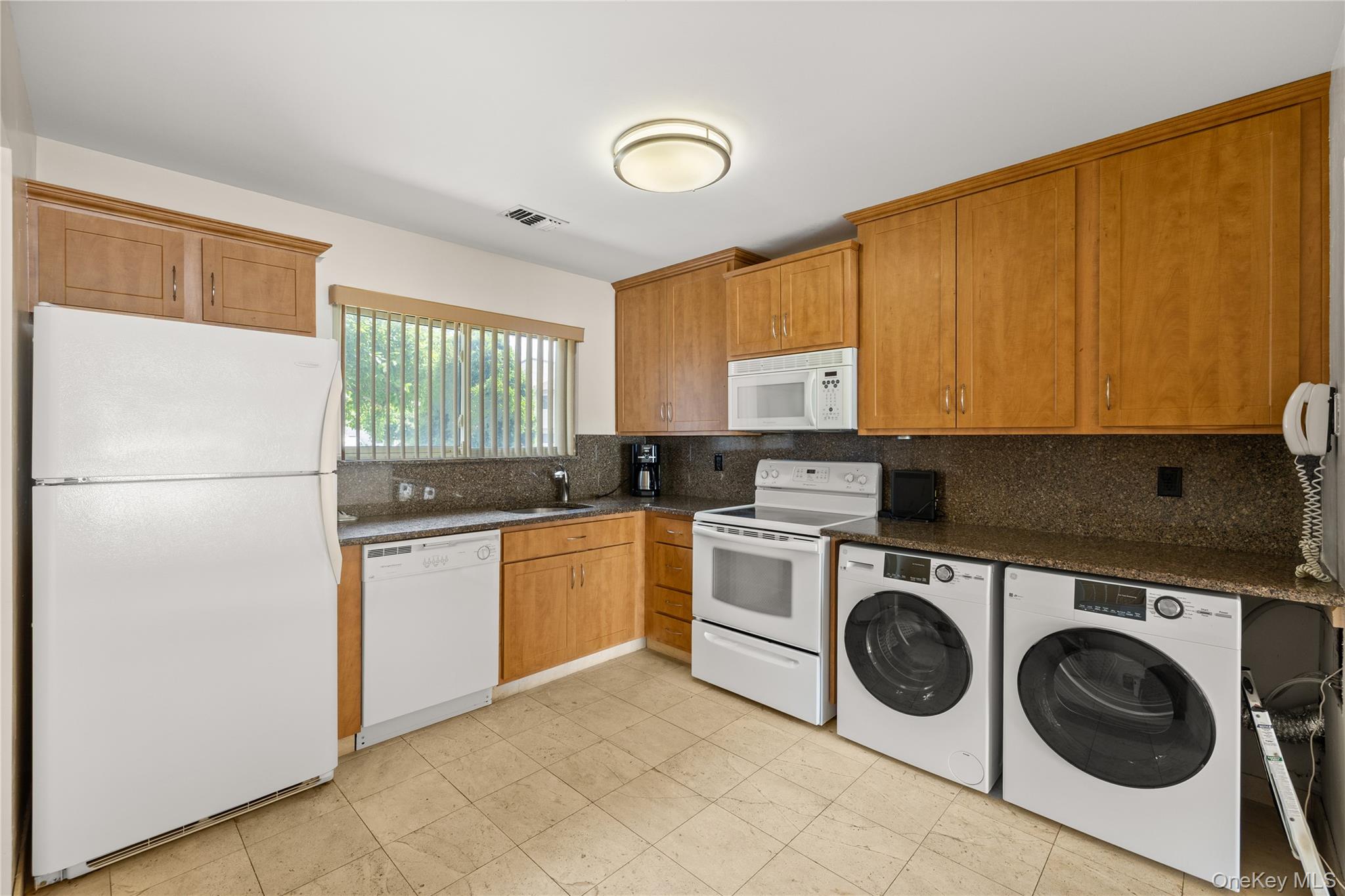 650 Newbridge Road, Unit 15 East Meadow, NY 11554 - Photo 4 of 20 a kitchen with a refrigerator and a stove top oven