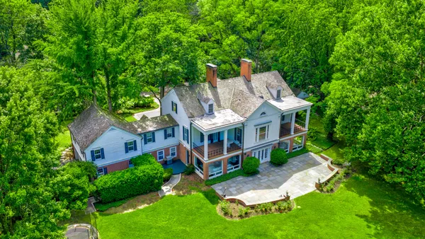 aerial view of a house with a yard table and chairs