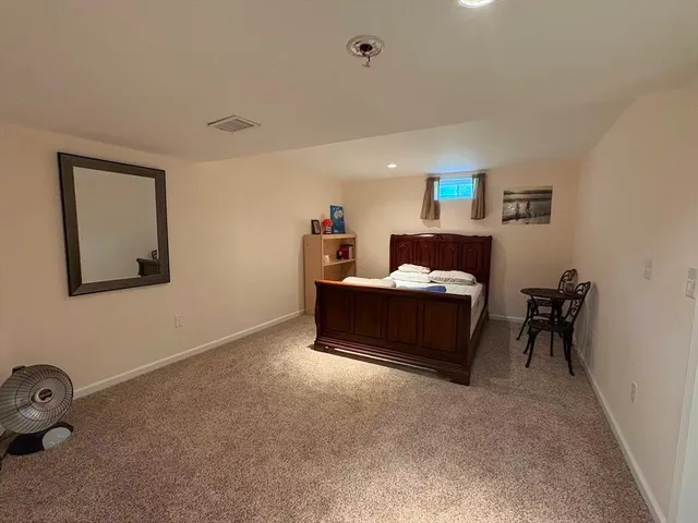 a bedroom with a bed and a table