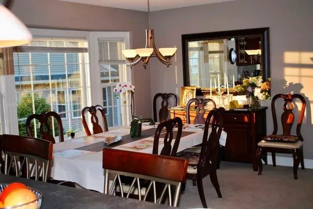 a view of a dining room with furniture and window