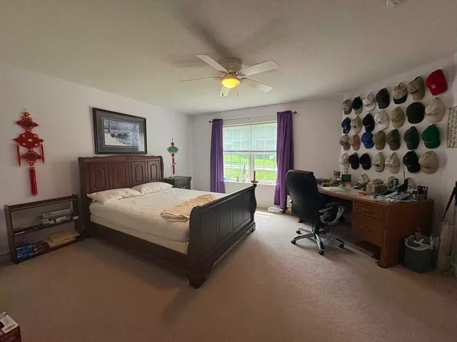 a bedroom with a bed dresser and a chair