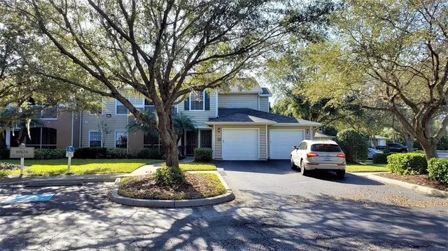 a view of a house with swimming pool and a small yard