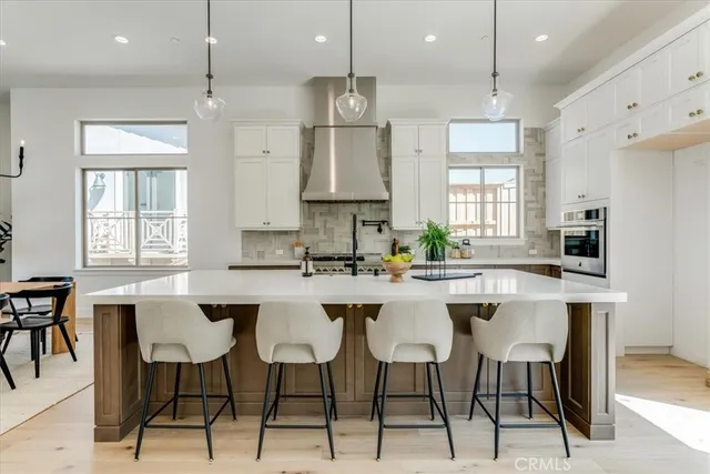 a kitchen with cabinets appliances and a dining table