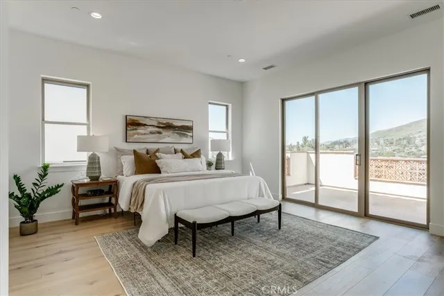 a bed room with furniture and a large window