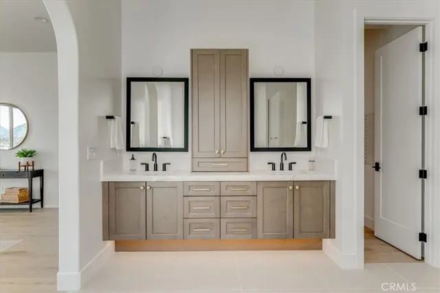 a bathroom with double vanity sinks and a mirror