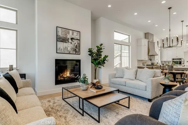 a living room with furniture fireplace and window