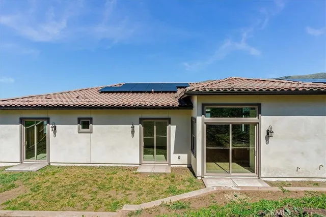 a front view of a house with a garden and yard