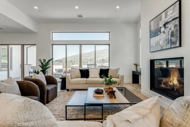 a living room with furniture large window and a fireplace