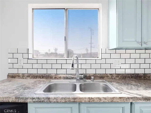 a white stove top oven sitting inside of a kitchen