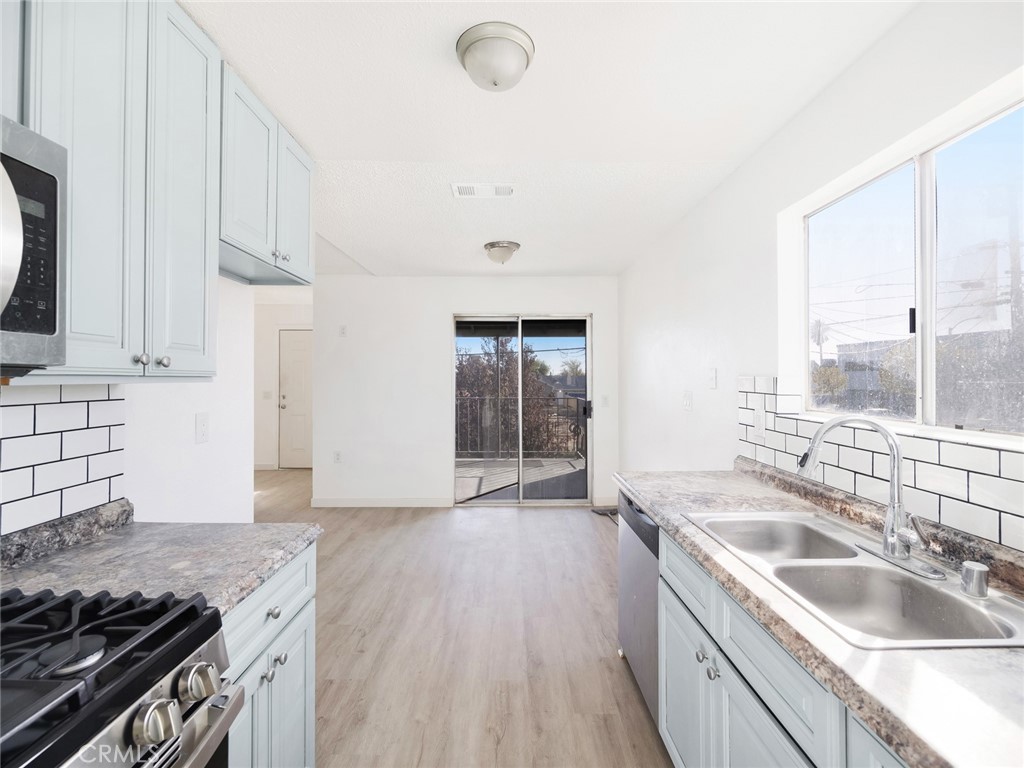 38423 10th Place East, Unit 3 Palmdale, CA 93550 - Photo 14 of 27 a kitchen that has a sink and a stove