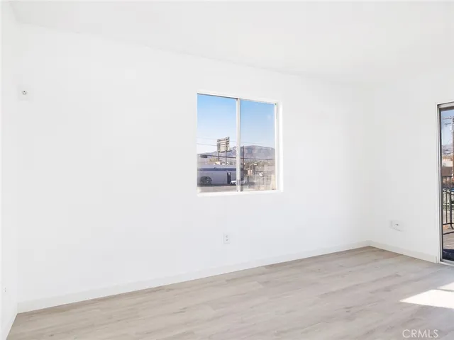 a view of a room with wooden floor
