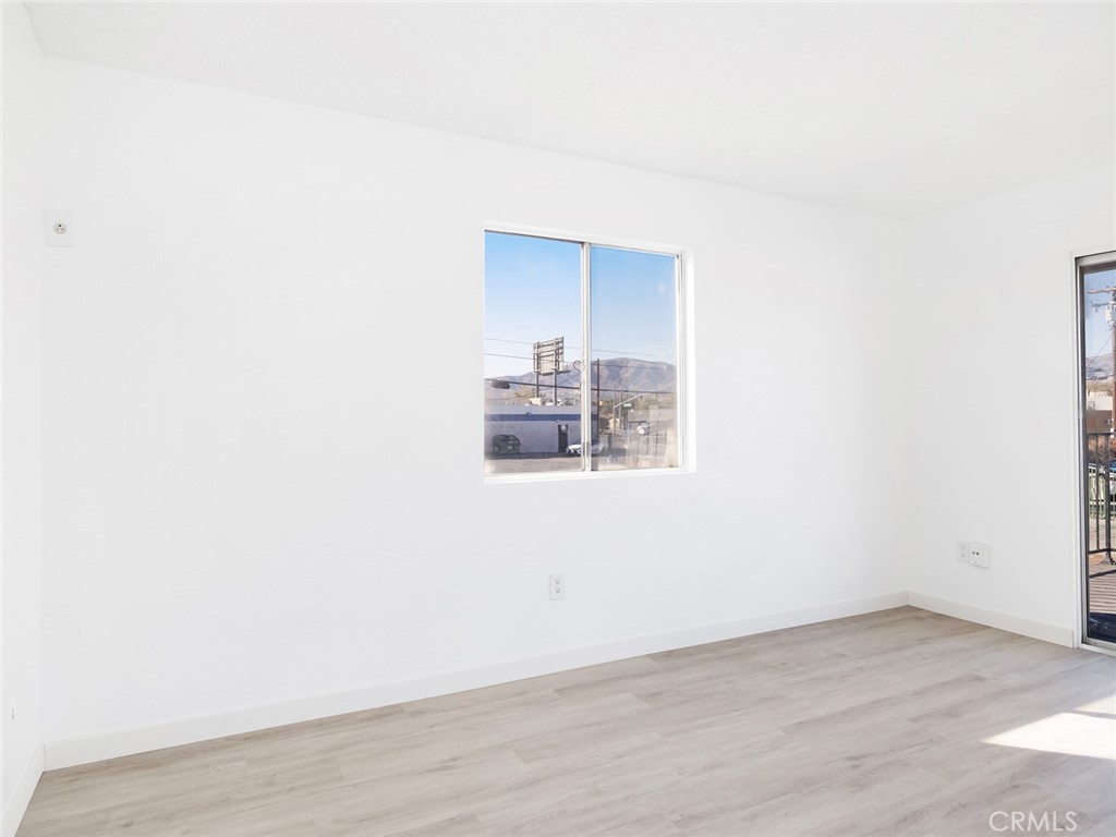 38423 10th Place East, Unit 3 Palmdale, CA 93550 - Photo 18 of 27 a view of a room with wooden floor