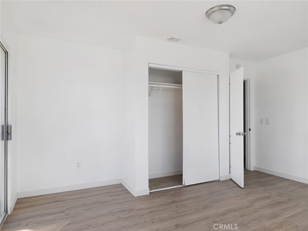 38423 10th Place East, Unit 3 Palmdale, CA 93550 - Photo 20 of 27 a view of an empty room with wooden floor