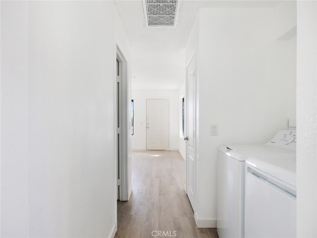 38423 10th Place East, Unit 3 Palmdale, CA 93550 - Photo 25 of 27 a view of a hallway with wooden floor