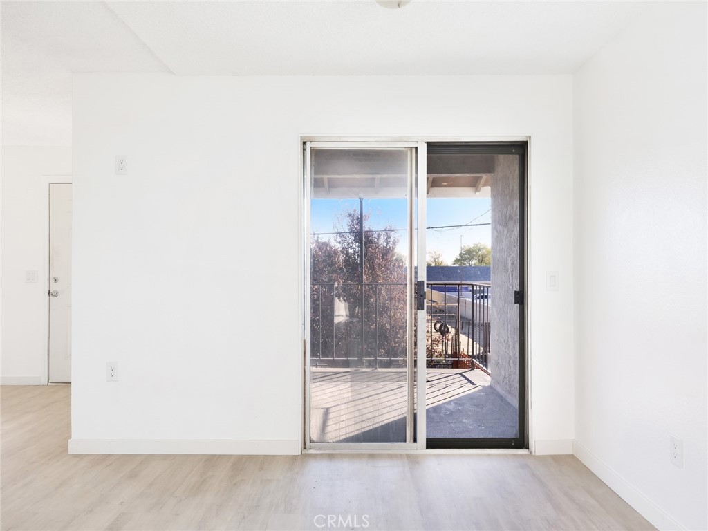 38423 10th Place East, Unit 3 Palmdale, CA 93550 - Photo 9 of 27 a view of a room with wooden floor and a bathroom