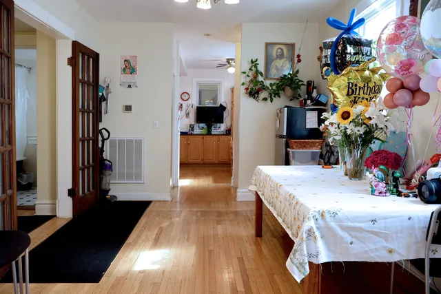 a dining room with furniture and a chandelier