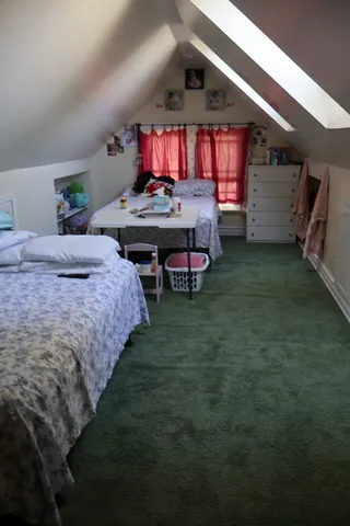 a bedroom with bed and a desk