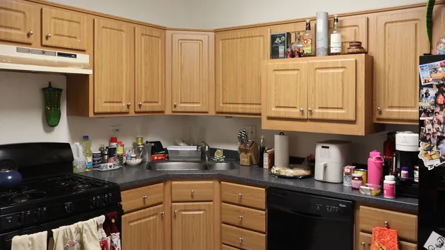 a kitchen with stainless steel appliances granite countertop a stove refrigerator and cabinets