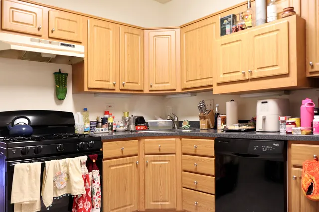 a kitchen with stainless steel appliances granite countertop a sink stove and cabinets