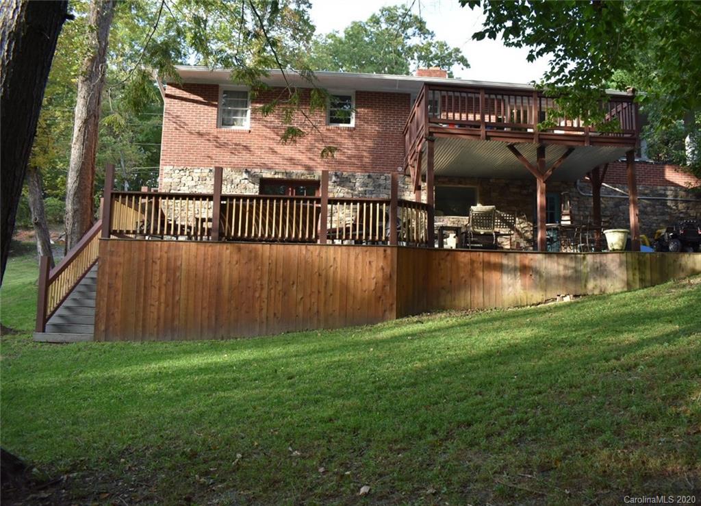 91 Country Club Road Tryon, NC 28782 - Photo 2 of 24 a view of a house with backyard and sitting area