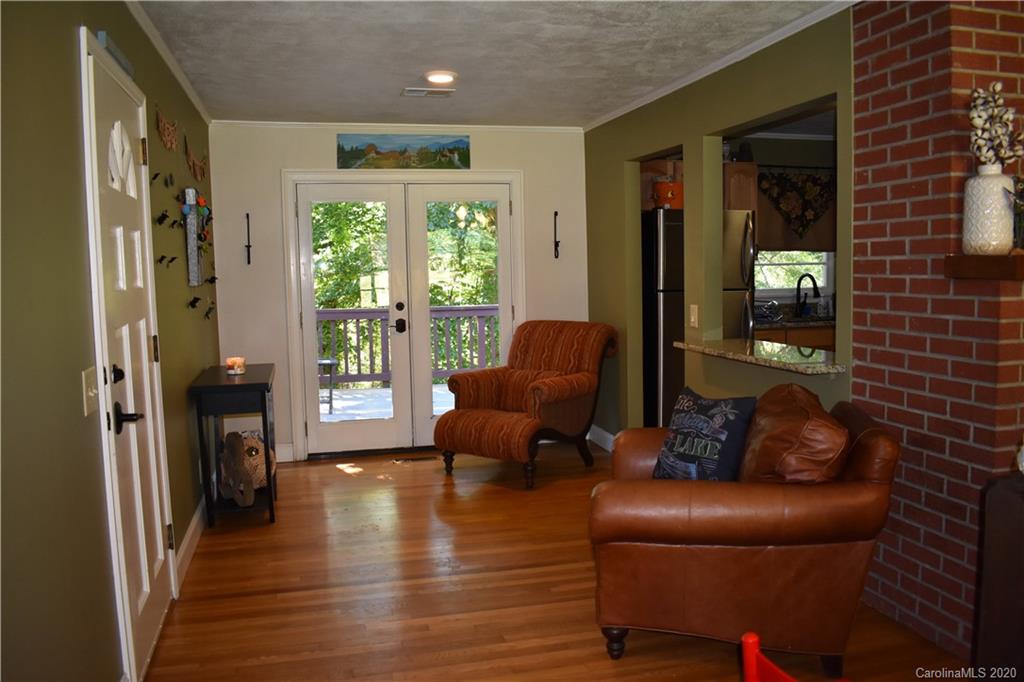 91 Country Club Road Tryon, NC 28782 - Photo 11 of 24 a living room with furniture and a fireplace