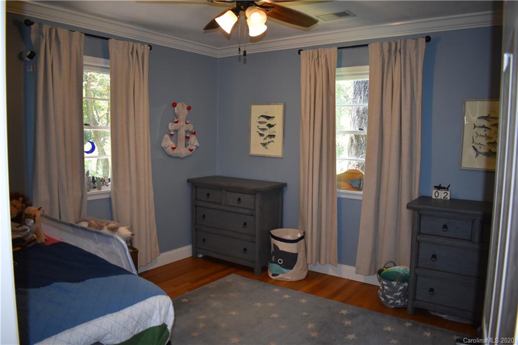 91 Country Club Road Tryon, NC 28782 - Photo 12 of 24 a bedroom with a bed and a dresser