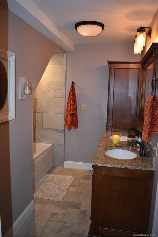 91 Country Club Road Tryon, NC 28782 - Photo 13 of 24 a bathroom with a sink and a mirror