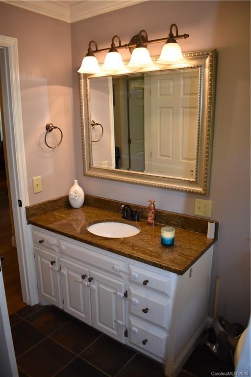 91 Country Club Road Tryon, NC 28782 - Photo 16 of 24 a bathroom with a granite countertop sink and a mirror