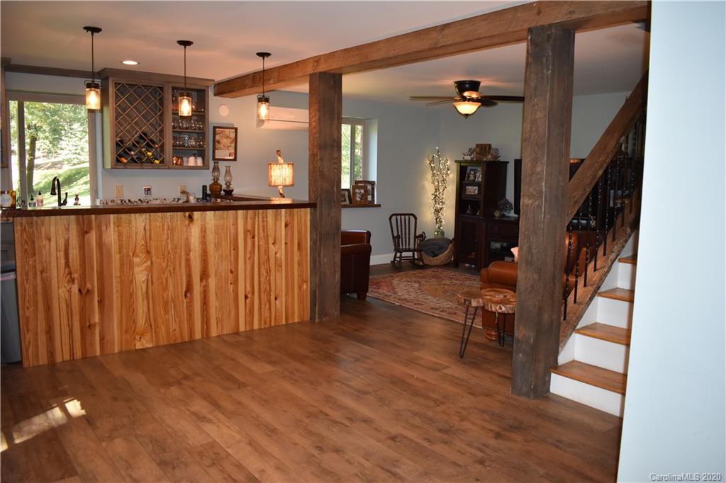 91 Country Club Road Tryon, NC 28782 - Photo 18 of 24 a view of a hallway with wooden floor and staircase