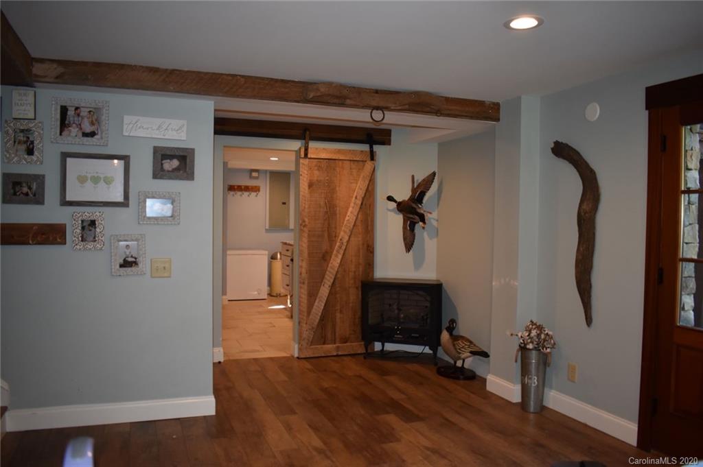 91 Country Club Road Tryon, NC 28782 - Photo 3 of 24 a view of a hallway with wooden floor and workspace