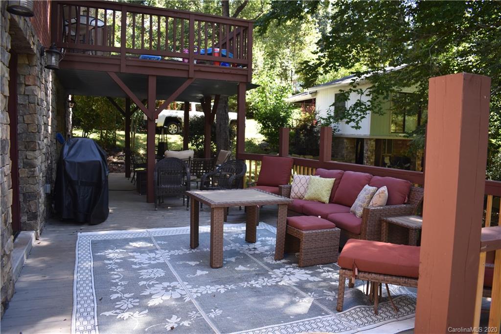 91 Country Club Road Tryon, NC 28782 - Photo 21 of 24 a outdoor living space with patio furniture and a fireplace