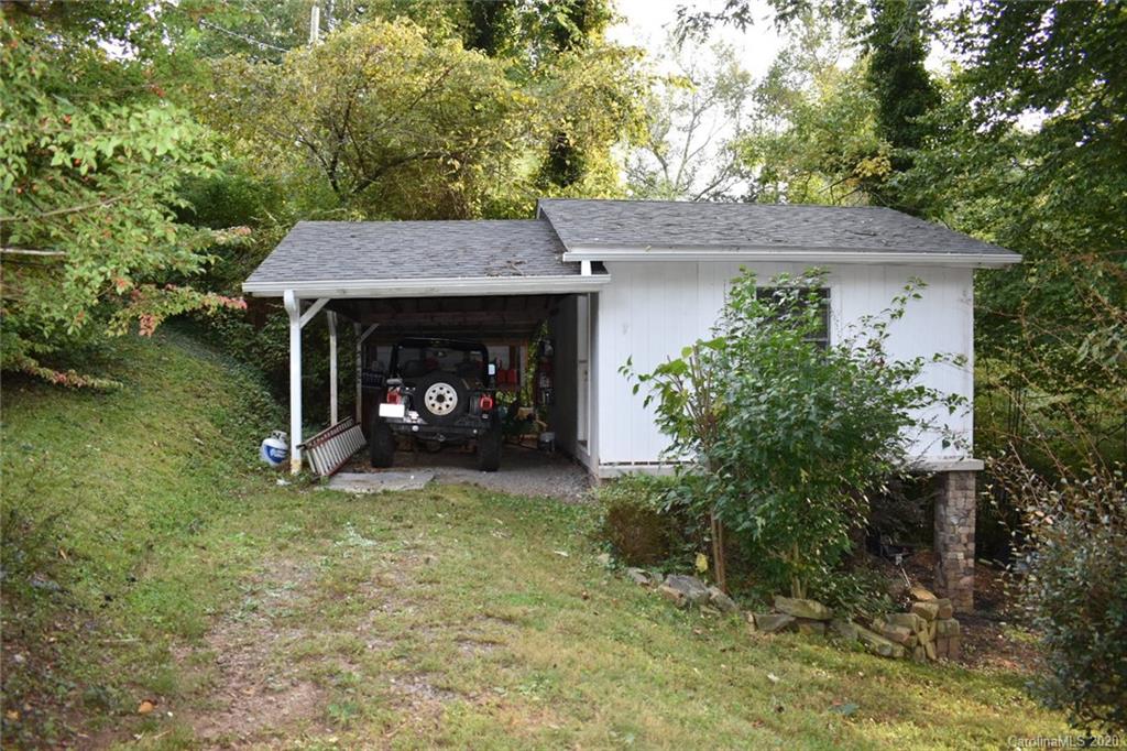 91 Country Club Road Tryon, NC 28782 - Photo 23 of 24 a view of a house with a small yard