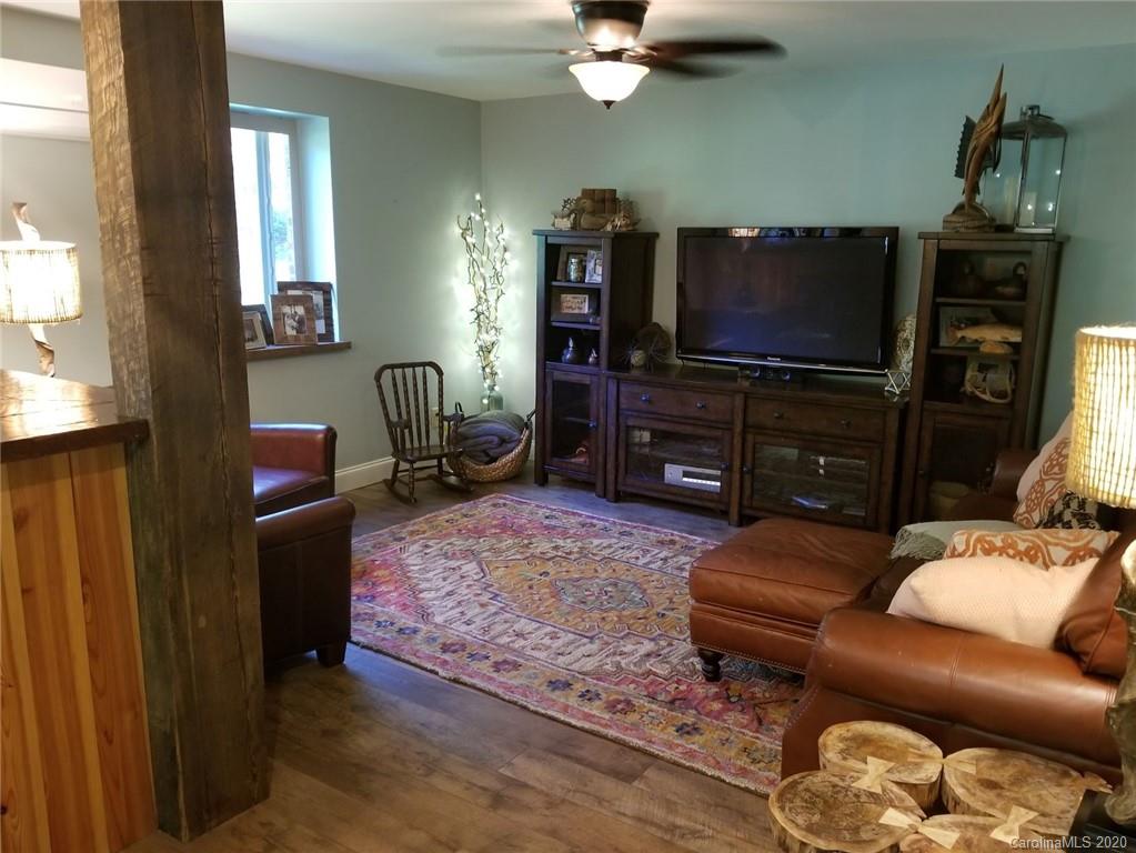 91 Country Club Road Tryon, NC 28782 - Photo 4 of 24 a living room with furniture and a flat screen tv