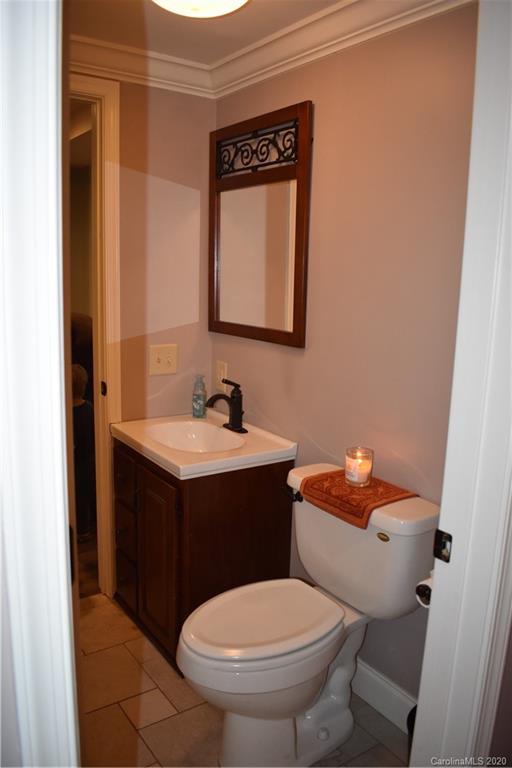 91 Country Club Road Tryon, NC 28782 - Photo 8 of 24 a bathroom with a toilet sink and mirror
