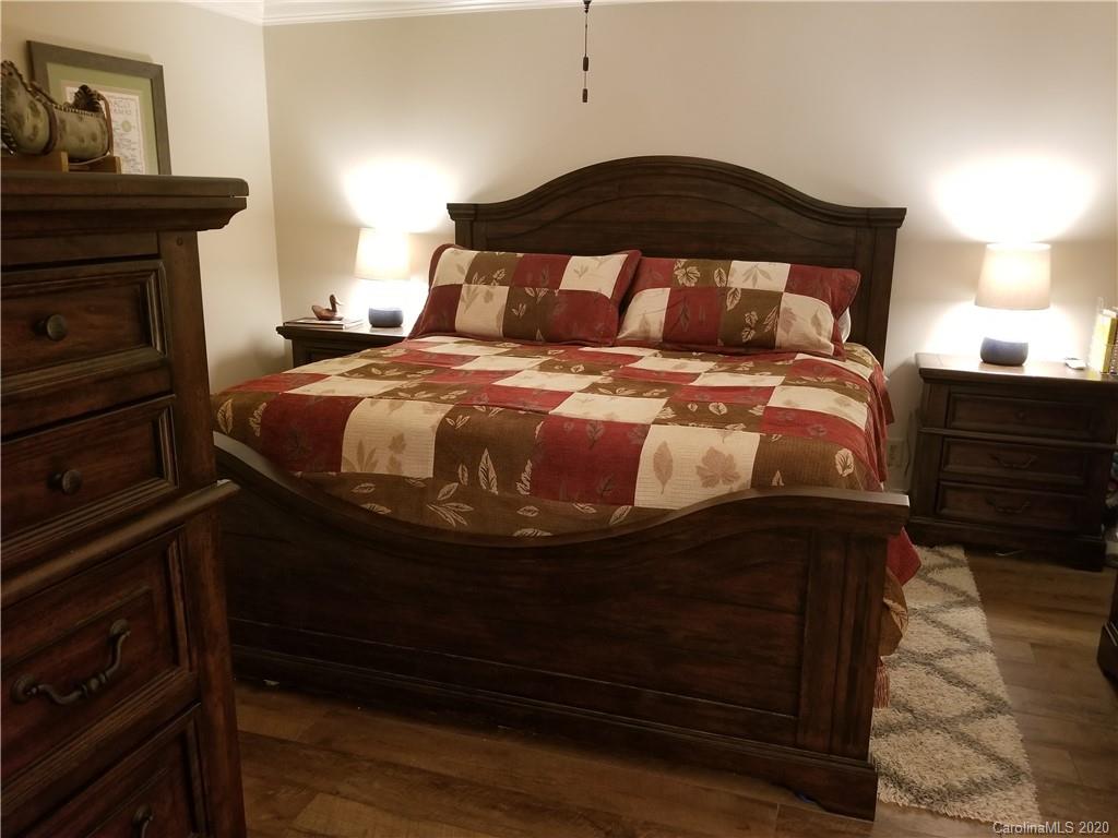 91 Country Club Road Tryon, NC 28782 - Photo 9 of 24 a bedroom with a bed and a fireplace