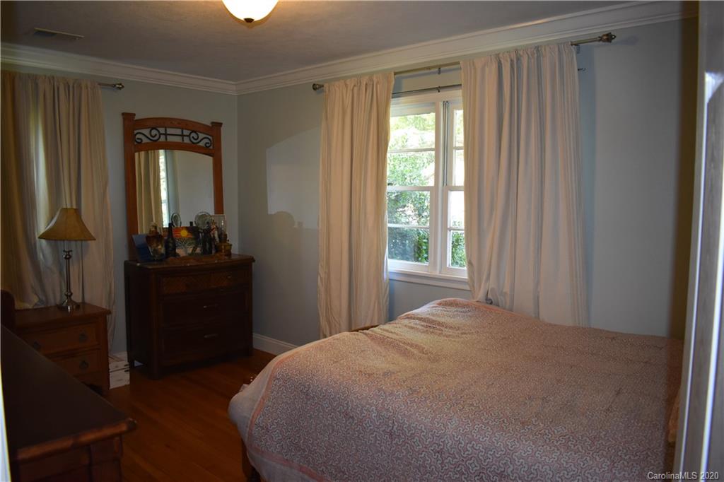 91 Country Club Road Tryon, NC 28782 - Photo 10 of 24 a bedroom with a bed and a window