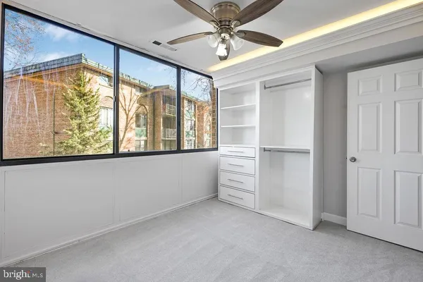 a view of empty room with cabinet and floor to ceiling window