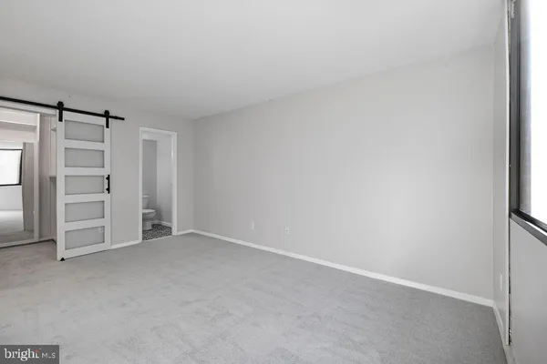a view of an empty room with closet area