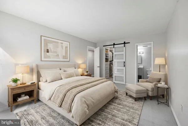 a bedroom with a bed and a couch