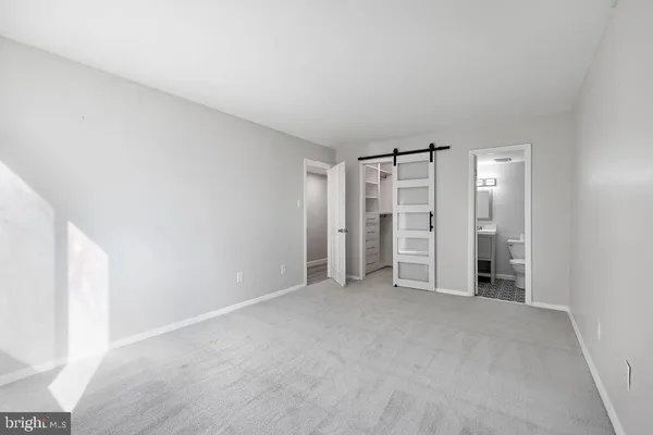 a view of empty room with kitchen