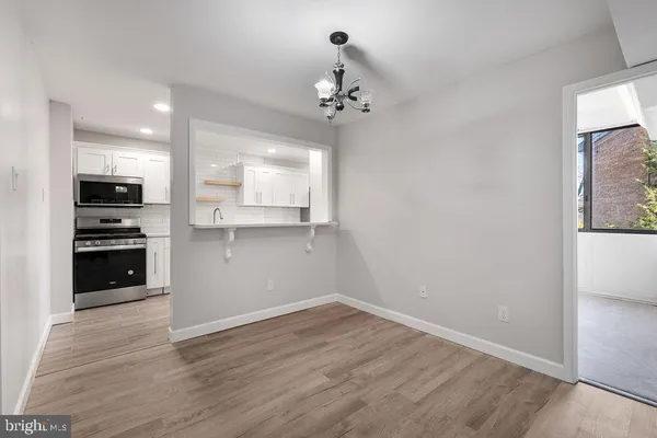 a view of a kitchen with a microwave and a stove top oven