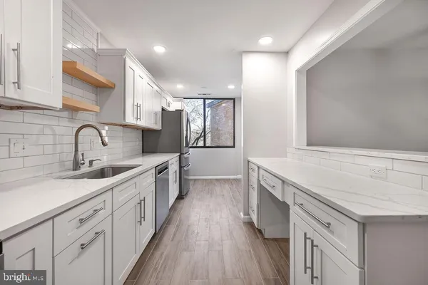 a large kitchen with a sink and cabinets